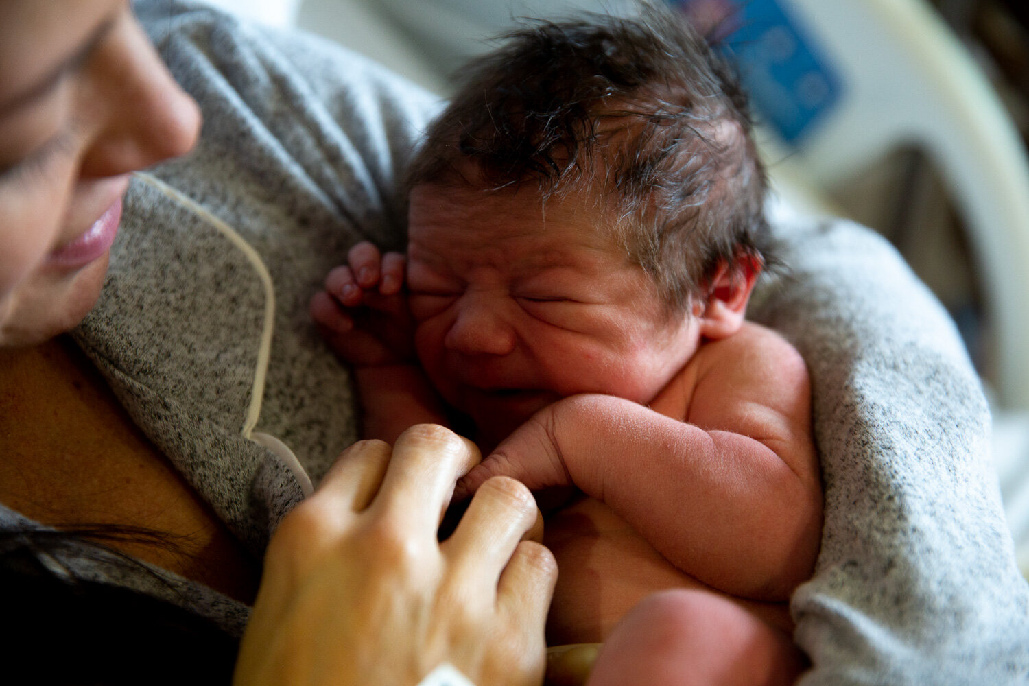 Newborn baby in mom's arms just after being born