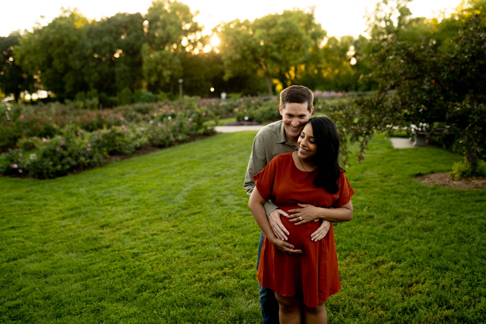 Man and woman posed in a Minneapolis park for a maternity photo session