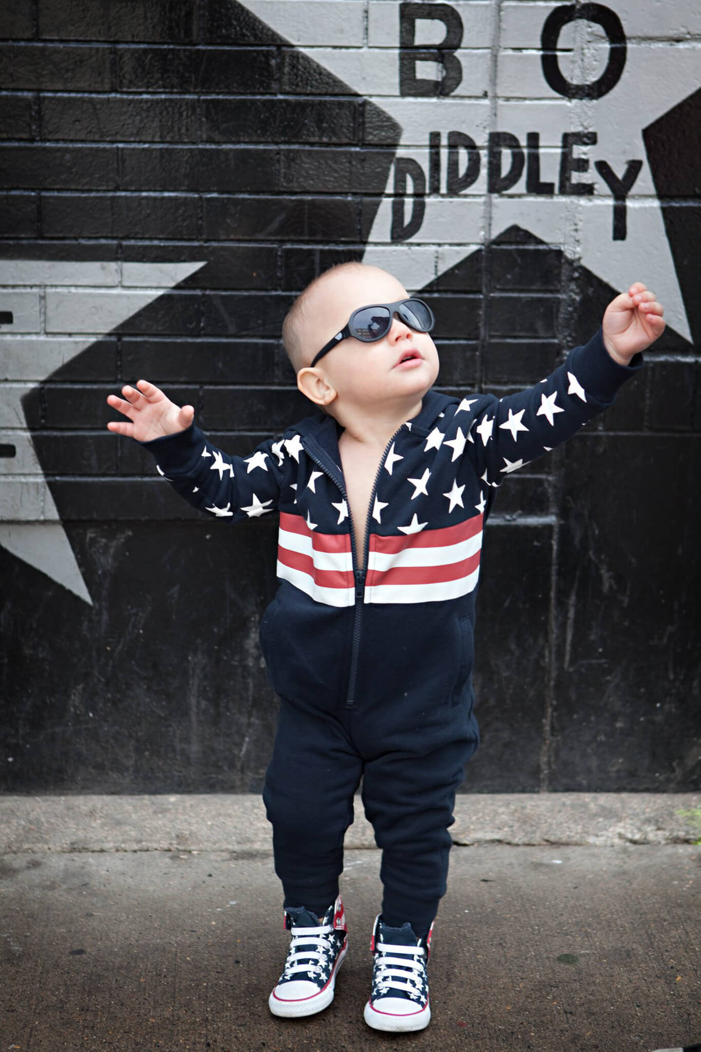 toddler wearing American flag union suit outside first ave Minnesota