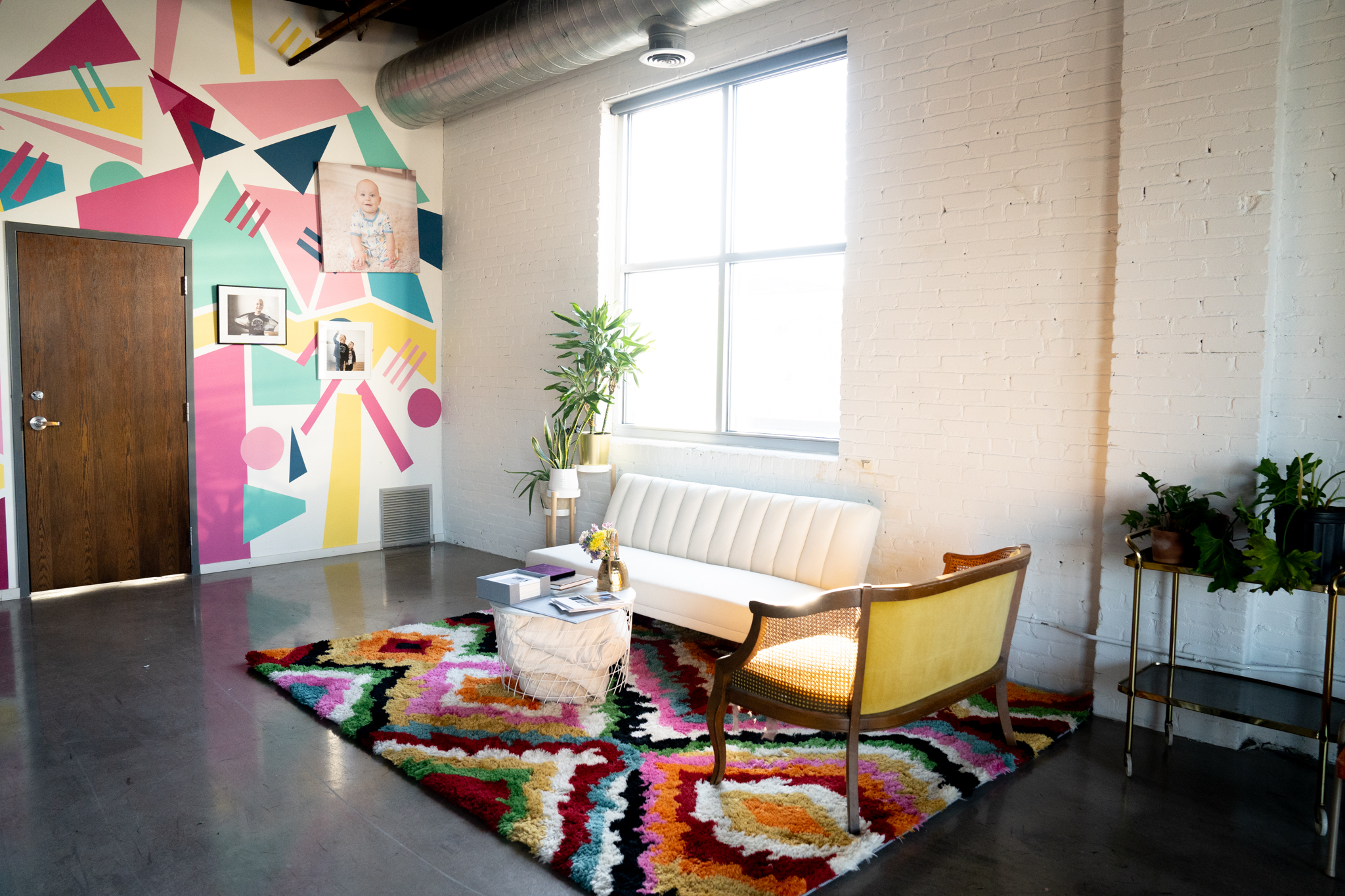 A vibrant rainbow run set with minimal couches and other furniture in a Minneapolis photography studio