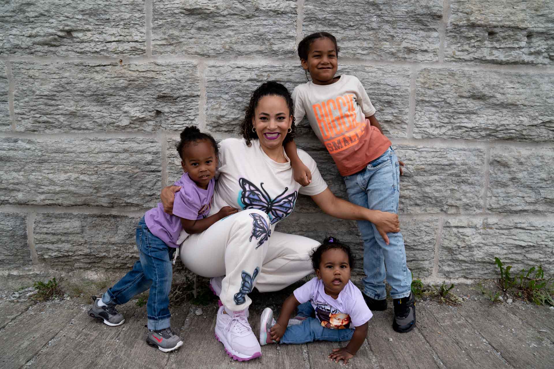 black mom is sweatsuit with three children at mill city ruins minneapolis