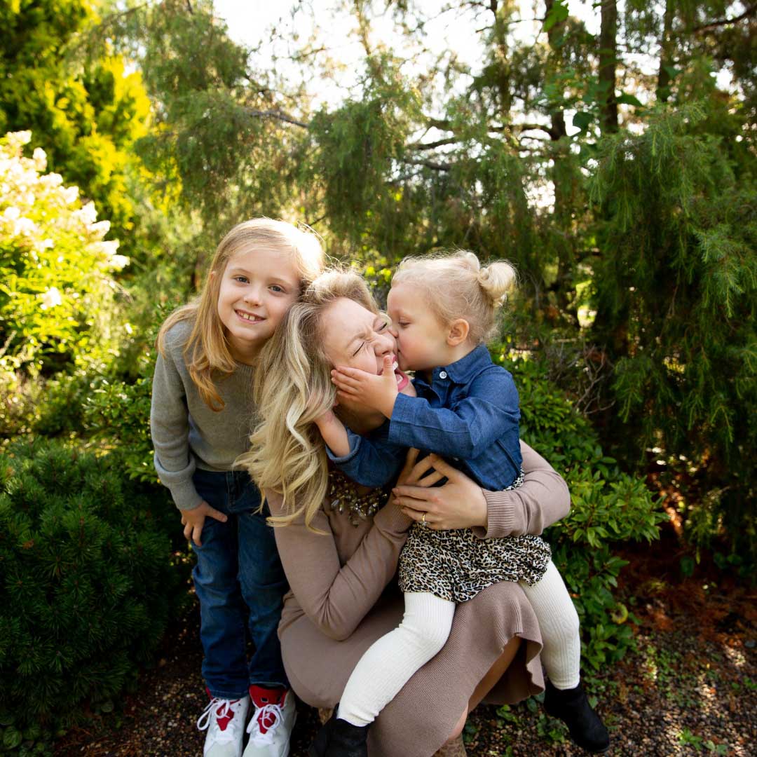 A mom hugging her two daughters during a Minneapolis Fall Mini Session