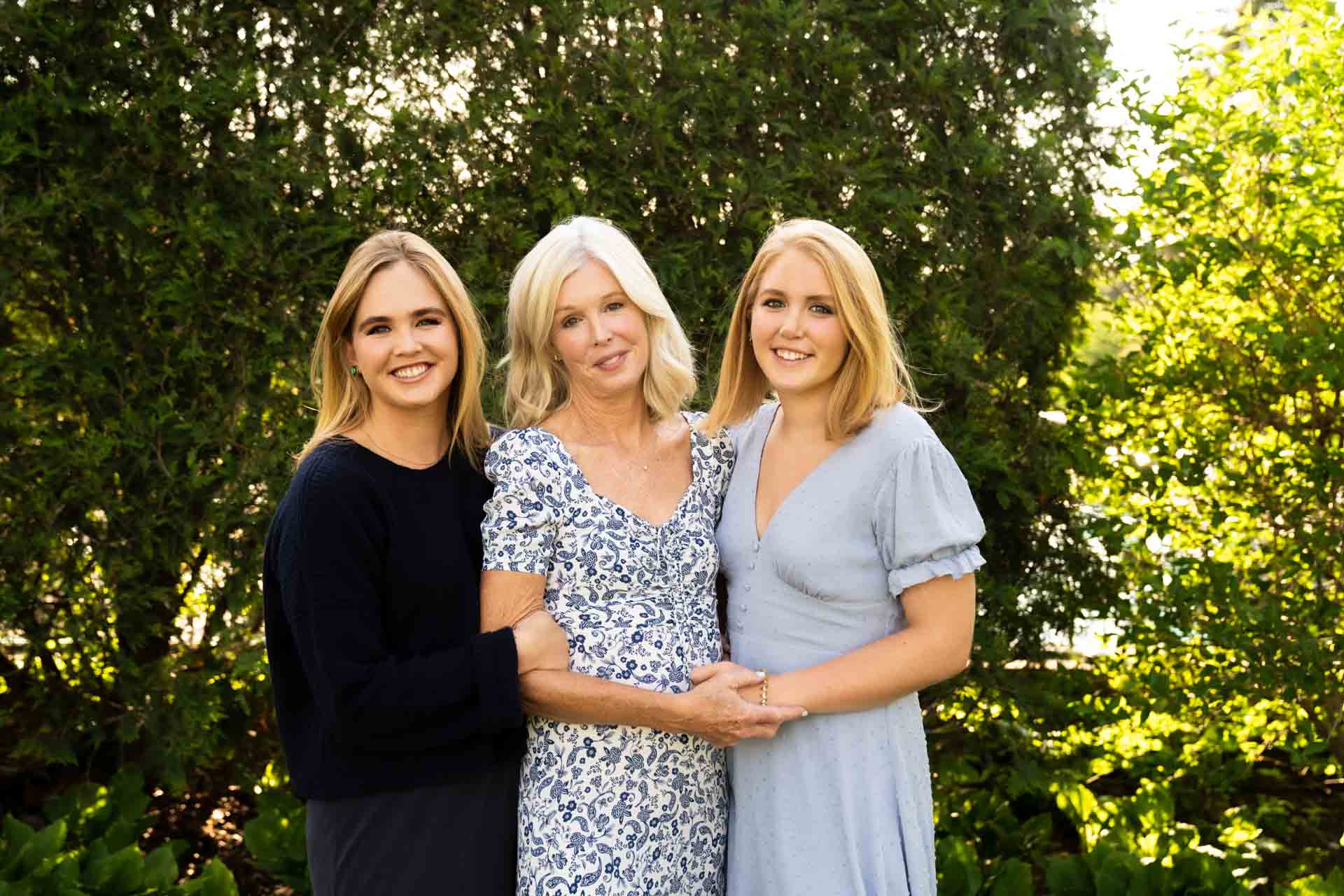 Family of four, standing together in their neutral, stylish Minneapolis home