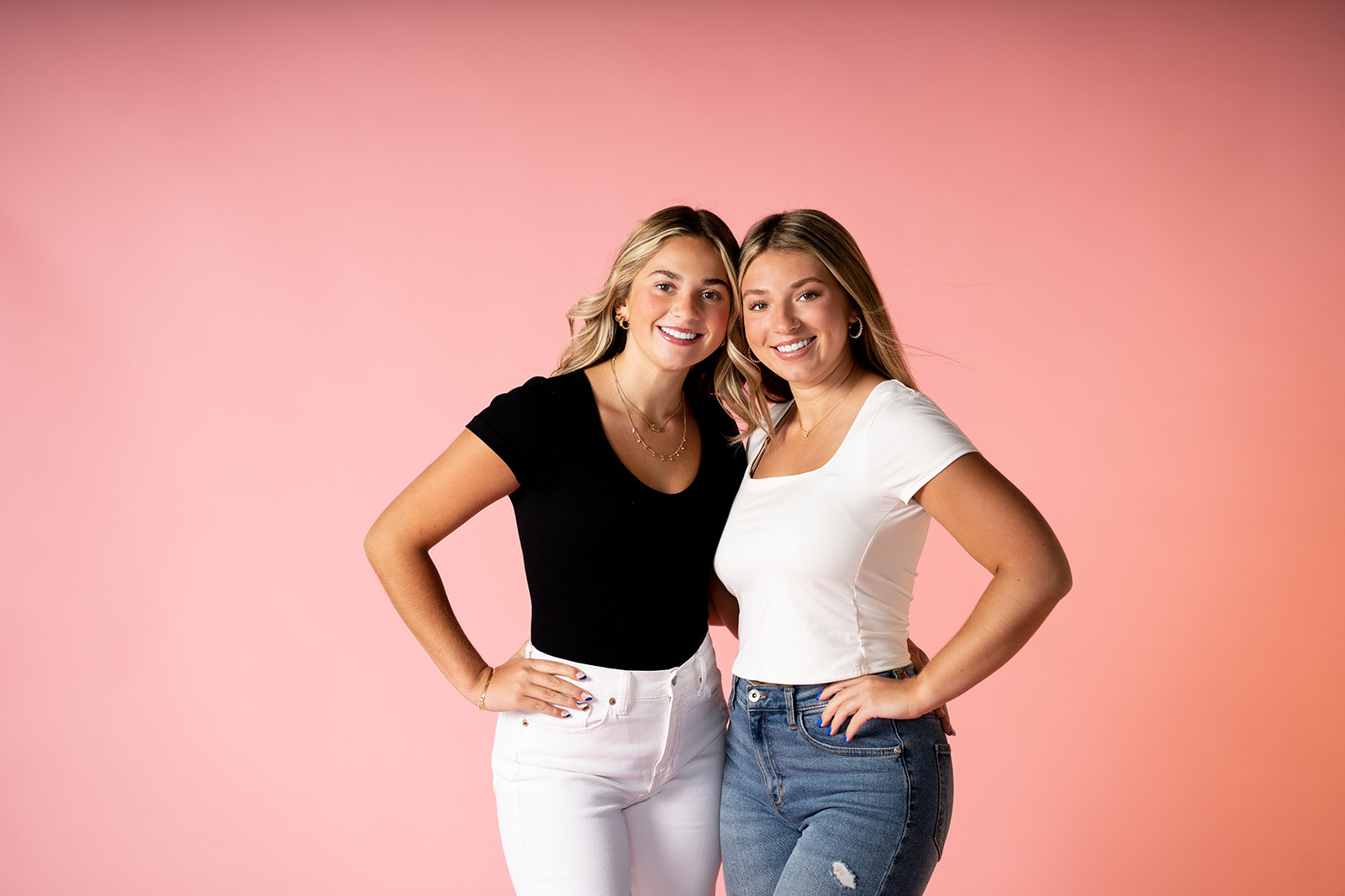 Best friends posed against a pink backdrop for Minneapolis senior pictures