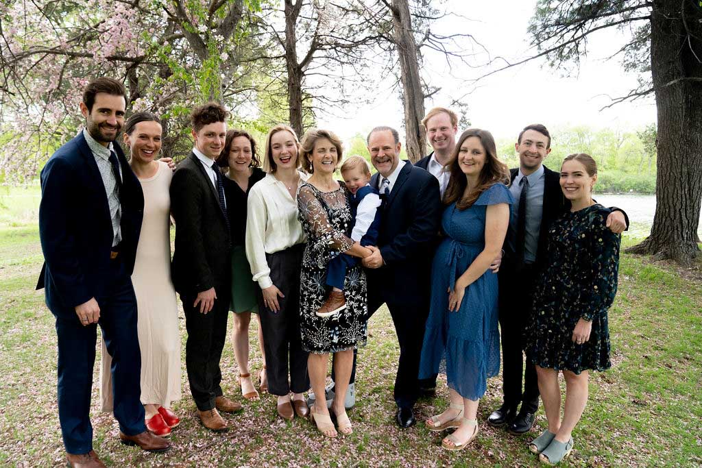 minneapolis-elopement-photography-93 a large family group standing together and laughing candidly at a Minneapolis micro-wedding